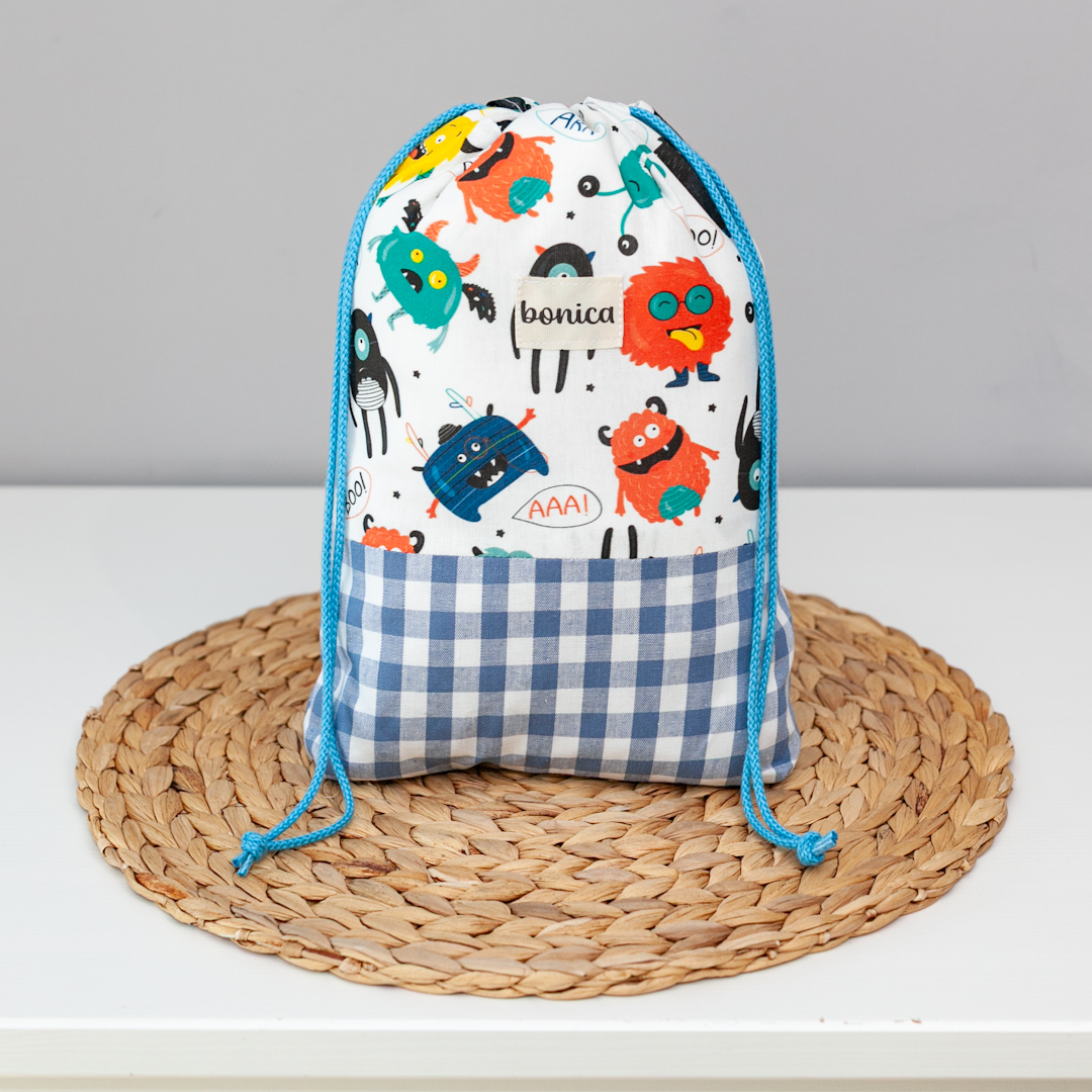 Saquito de muda artesanal para bebé con estampado de monstruos divertidos y coloridos, hecho a mano