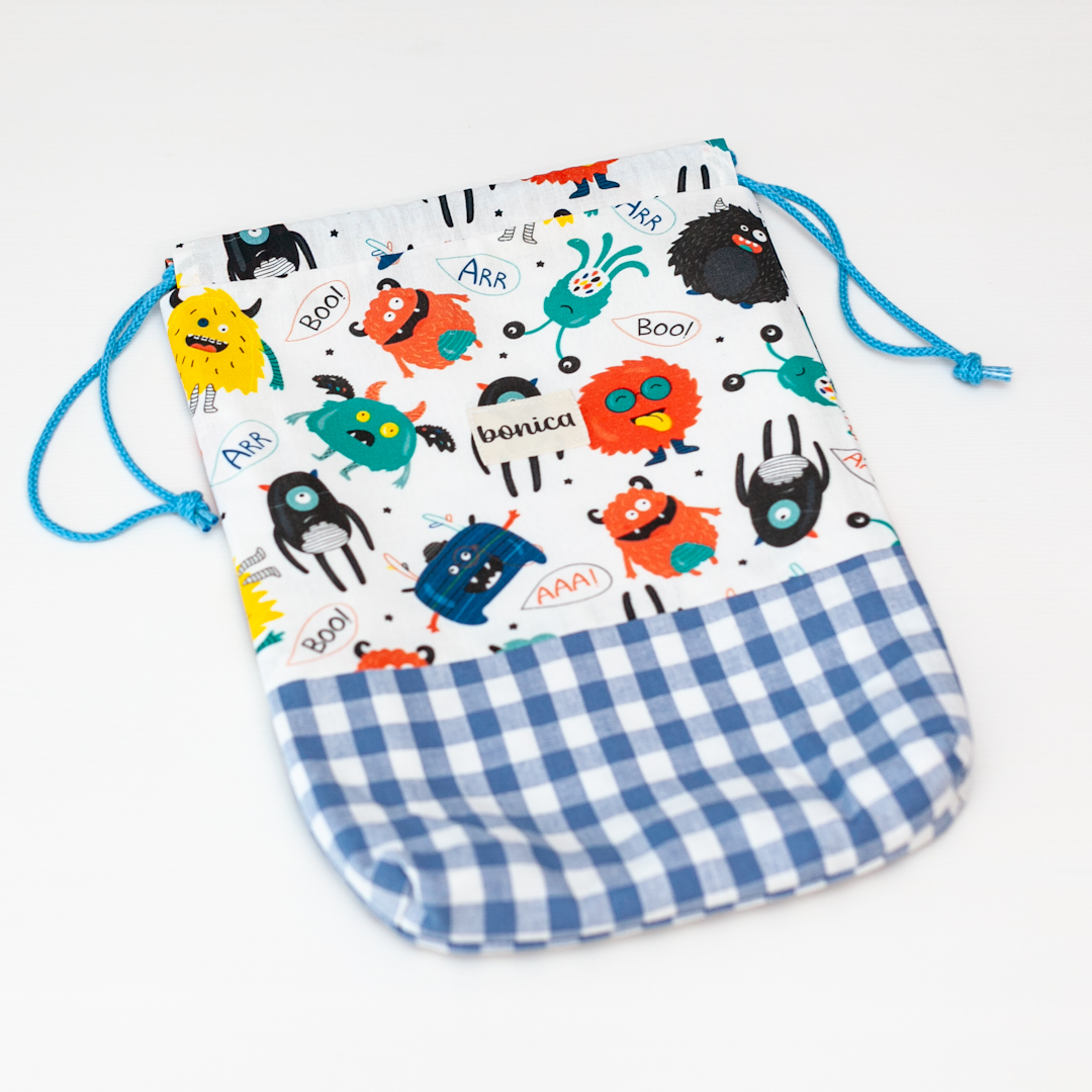 Bolsa de muda artesanal para bebé con estampado de monstruos multicolor